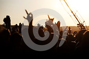 hands of happy people crowd having fun at stage at summer live rock fest