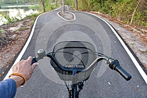 Hands and heads of bicycles coming to a crossroads and having to choose which way