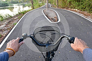 Hands and heads of bicycles coming to a crossroads and having to choose which way