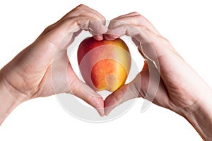 Hands in heart form concluding apple inside