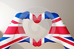 hands in heart gesture painted in flag United Kingdom