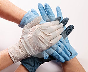 Hands of heathcare workers gloves stacked photo