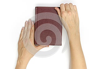 Hands hold blank red hardcover book on white background