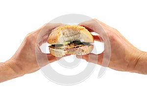 Hands hold a burger
