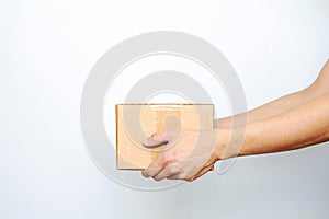 Hands hold a cardboard box for online grocery and food delivery on a white  background with copy space. The concept of