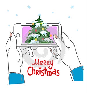 Hands hold the mobile phone, smartphone with Christmas tree. Communication concept for Christmas or New Year holidays