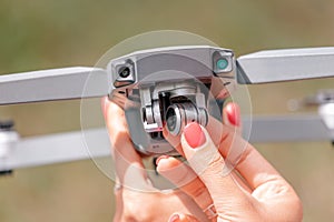 hands hold the ua drone and check the functionality of the camera suspension and gimbal