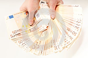 Hands holding 5000 euro in banknotes photo