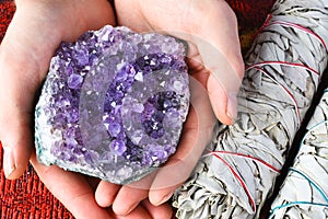 Hands Holding Amethyst Geode Crystals