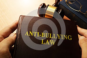 Hands holding Anti-Bullying Law.