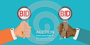 Hands holding auction paddle