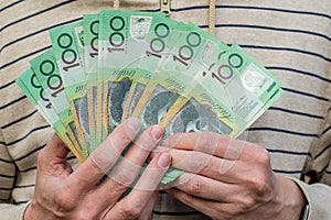 Hands holding australian dollars 100 banknotes. Finance and payment