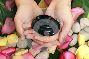 Hands holding basalt stones