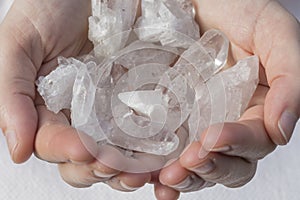 Hands holding beautiful quartz clusters