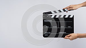 Hands is holding black Clapperboard or movie slate. it use in video production ,film, cinema industry on white background