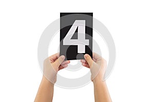 Hands are holding a black paper card with number 4 isolated on white background