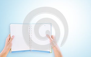 Hands holding a blank book