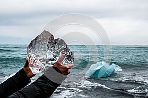Hands holding a block of pristine glacier ice photo