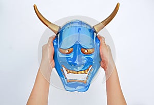 Hands holding blue Kabuki Mask on white background