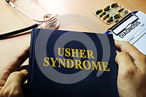 Hands holding book Usher syndrome. photo