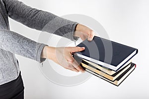 Hands holding books on white background, education background