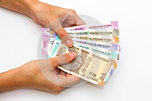 Hands holding brand new 500 indian rupees banknotes