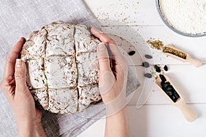 Hands Holding Brown Bread Loaf Fresh Baked Flatlay