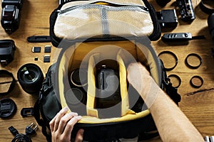 Hands holding a camera bag preparing put an equipment in