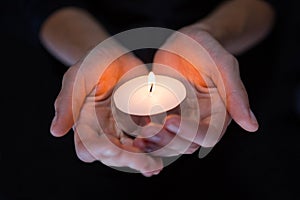 Hands holding candle