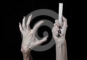 Hands holding a candle, a candle is lit, black background, solitude, warmth, in the dark, Hands death, hands witch