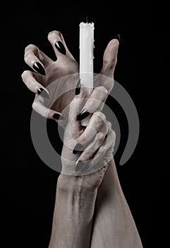 Hands holding a candle, a candle is lit, black background, solitude, warmth, in the dark, Hands death, hands witch