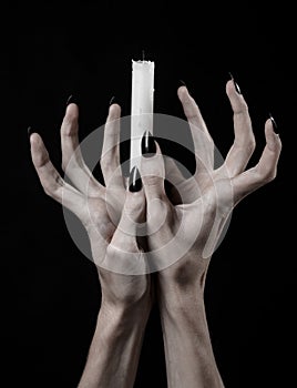 Hands holding a candle, a candle is lit, black background, solitude, warmth, in the dark, Hands death, hands witch