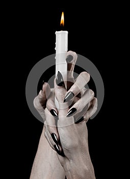 Hands holding a candle, a candle is lit, black background, solitude, warmth, in the dark, Hands death, hands witch