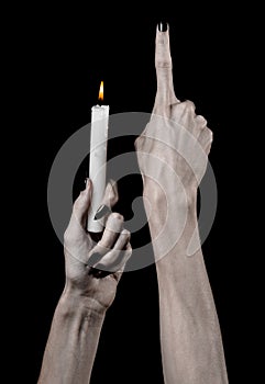 Hands holding a candle, a candle is lit, black background, solitude, warmth, in the dark, Hands death, hands witch