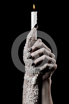 Hands holding a candle, a candle is lit, black background, solitude, warmth, in the dark, Hands death, hands witch