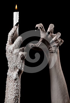 Hands holding a candle, a candle is lit, black background, solitude, warmth, in the dark, Hands death, hands witch