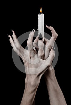 Hands holding a candle, a candle is lit, black background, solitude, warmth, in the dark, Hands death, hands witch