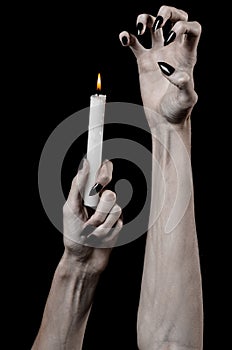 Hands holding a candle, a candle is lit, black background, solitude, warmth, in the dark, Hands death, hands witch