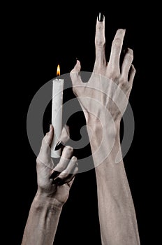 Hands holding a candle, a candle is lit, black background, solitude, warmth, in the dark, Hands death, hands witch