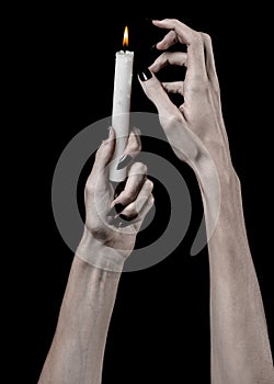 Hands holding a candle, a candle is lit, black background, solitude, warmth, in the dark, Hands death, hands witch