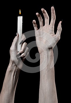 Hands holding a candle, a candle is lit, black background, solitude, warmth, in the dark, Hands death, hands witch