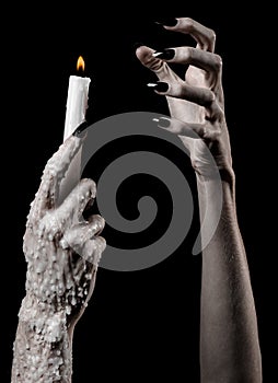 Hands holding a candle, a candle is lit, black background, solitude, warmth, in the dark, Hands death, hands witch