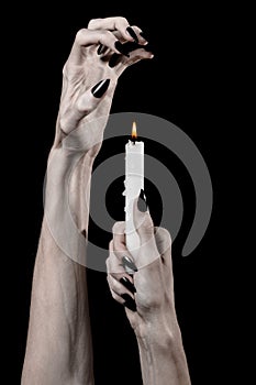 Hands holding a candle, a candle is lit, black background, solitude, warmth, in the dark, Hands death, hands witch