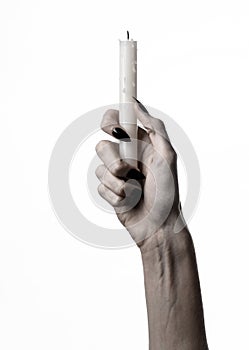 Hands holding a candle, a candle is lit, white background, solitude, warmth, in the dark, Hands death, hands witch