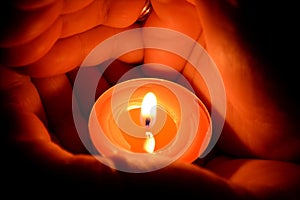 Hands holding a candle