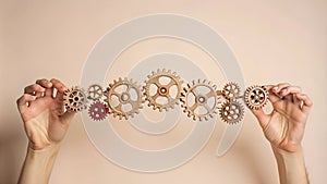 Hands Holding a Chain of Gears - Symbolizing Financial Systems