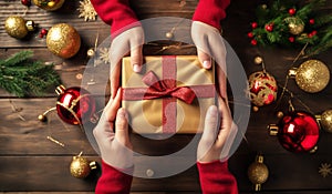 Hands holding a Christmas gift, which is on a wooden table with Christmas decorations. AI generated