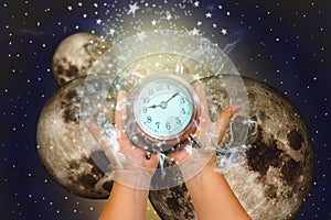 Hands holding a clock and high noon. Concept time to global changes.Elements of this image furnished by NASA