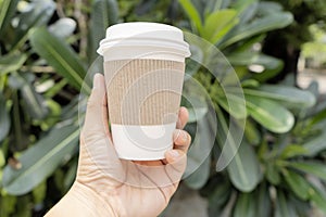 Hands holding a coffee cup that can be recycled, Coffee is one of the most popular drinks.
