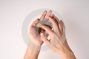 Hands holding coins money on white background